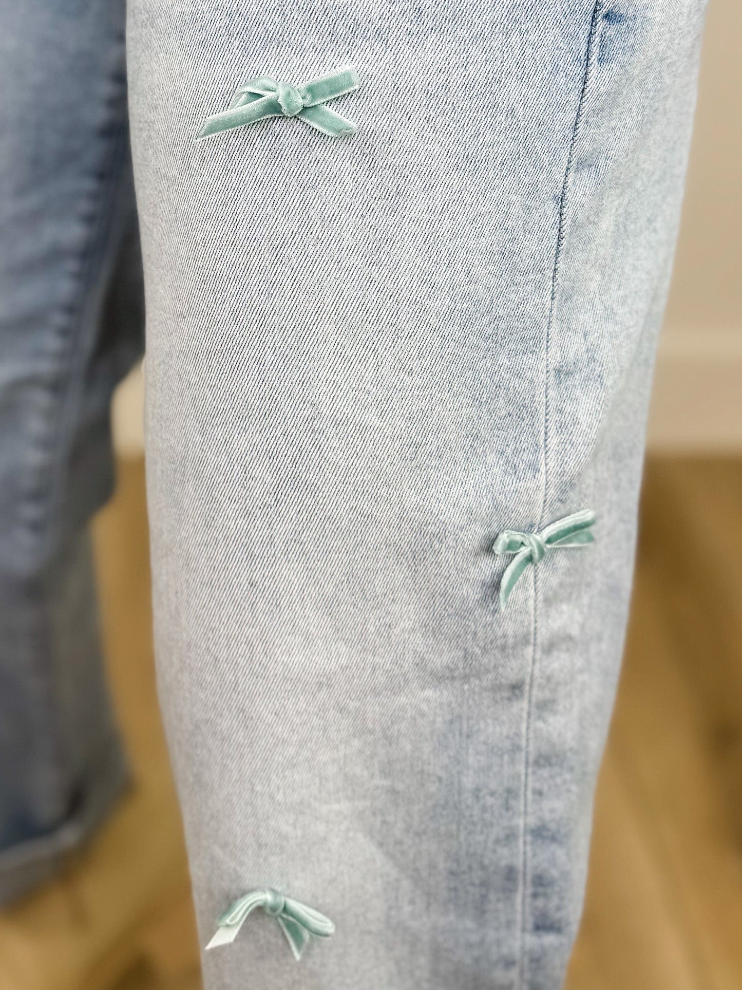 Risen Cassidy High-Rise Barrel Leg Bow Detail Light Wash Cropped Blue Jeans