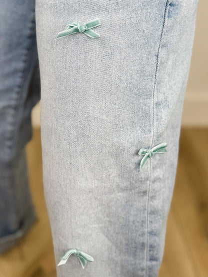 Risen Cassidy High-Rise Barrel Leg Bow Detail Light Wash Cropped Blue Jeans